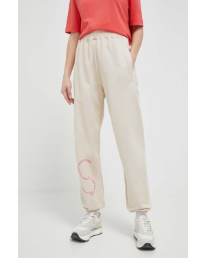 adidas by Stella McCartney spodnie dresowe bawełniane kolor beżowy z nadrukiem