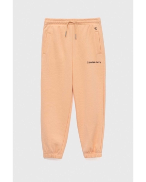 Calvin Klein Jeans spodnie dresowe dziecięce kolor pomarańczowy gładkie