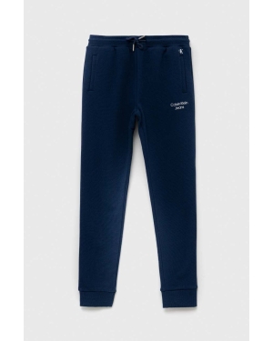 Calvin Klein Jeans spodnie dresowe dziecięce kolor granatowy gładkie