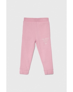 Guess spodnie dresowe bawełniane dziecięce kolor różowy z nadrukiem