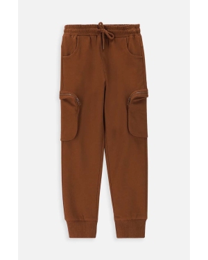 Coccodrillo spodnie dresowe bawełniane dziecięce kolor brązowy gładkie
