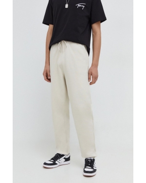 Tommy Jeans spodnie dresowe bawełniane kolor beżowy gładkie DM0DM18378