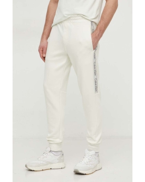 Calvin Klein spodnie dresowe kolor beżowy z aplikacją