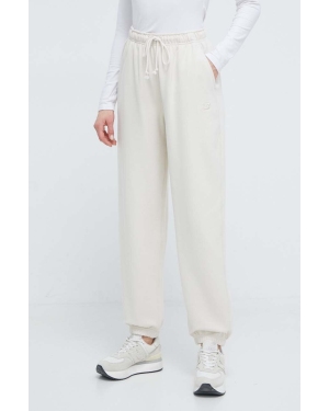 New Balance spodnie dresowe bawełniane kolor beżowy gładkie