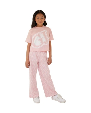 Guess spodnie dresowe dziecięce kolor różowy wzorzyste