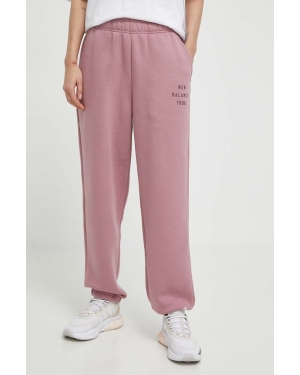 New Balance spodnie dresowe kolor różowy gładkie WP41508RSE