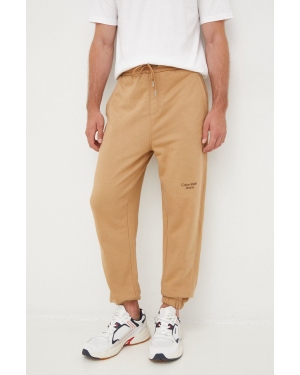 Calvin Klein Jeans spodnie dresowe bawełniane męskie kolor brązowy z nadrukiem